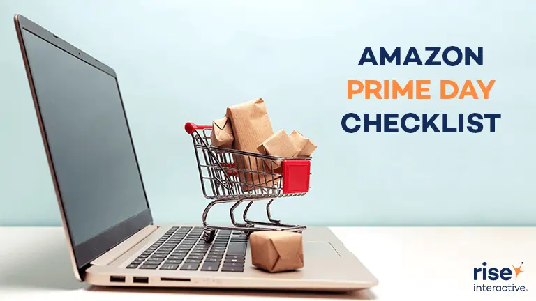 Laptop with mini shopping cart overflowing with packages on keyboard and text 'Amazon Prime Day 2020 Checklist' in corner